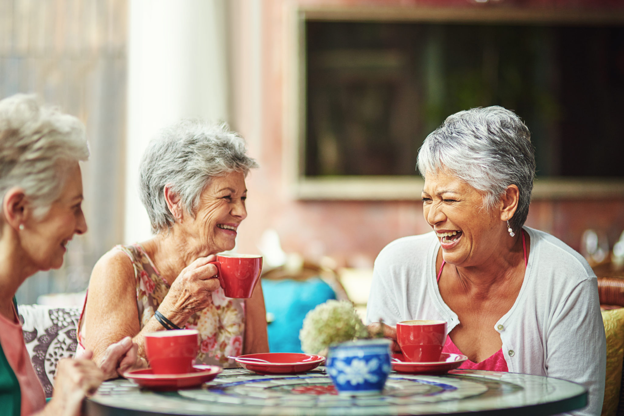 happy seniors dining and drinking coffee at a restaurant at the community