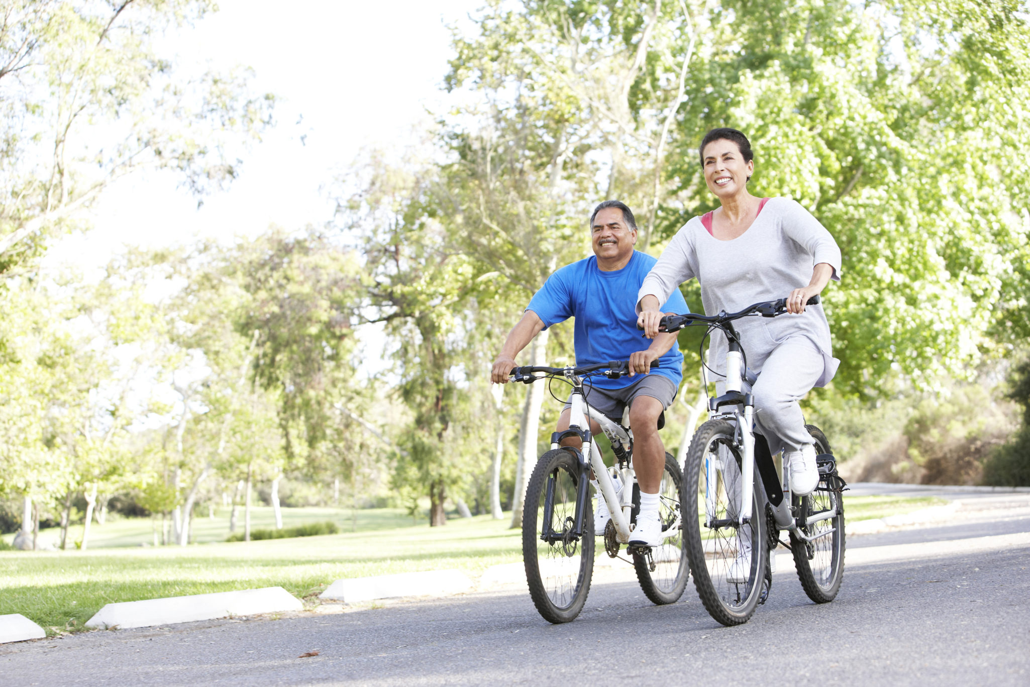 seniors biking outside on a sunny day