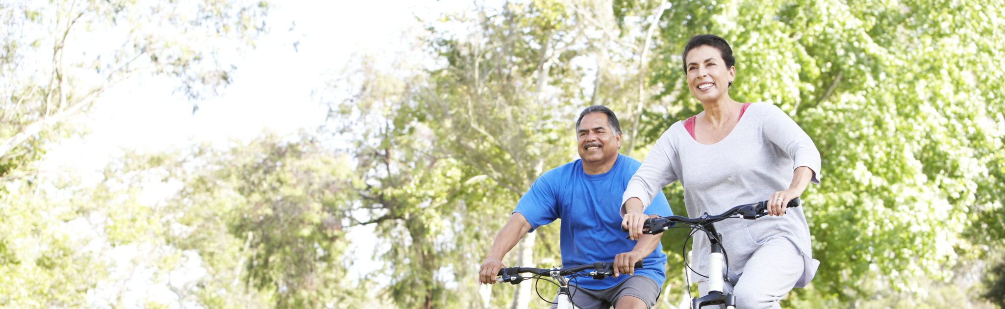 seniors biking outside on a sunny day